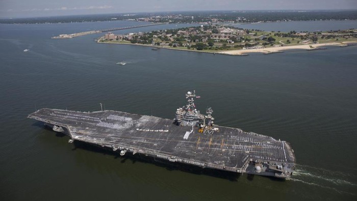 FILE - The aircraft carrier USS Harry S. Truman passes Fort Monroe as it transits the Chesapeake Bay on its way into dock in Norfolk, Va., July 13, 2016. Defense Secretary Lloyd Austin has ordered a U.S. Navy aircraft carrier strike group to stay in the Mediterranean Sea region rather than move on to the Middle East, amid worries about the buildup of thousands of Russian troops near the Ukraine border. A defense official said Tuesday, Dec. 28, 2021, that the change in the schedule of the USS Harry S. Truman, and the five American warships accompanying it, reflects the need for a persistent presence in Europe. (Randall Greenwell/The Virginian-Pilot via AP, File)