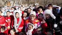 Jackie Chan berfoto bersama anak-anak setelah mengikuti estafet obor Olimpiade Musim Dingin 2022 di Tembok Besar Badaling di pinggiran Beijing, China.