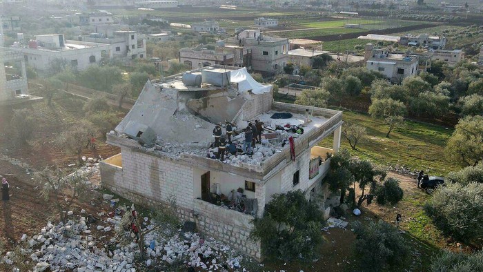 A Syrian civil defence team surveys the damage to a two-storey house on the outskirts of the rebel-held town of Atme that appears to have been one of the main targets of the US raid (Aaref WATAD/AFP)