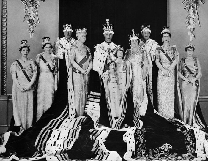 FILE - Britains King George VI, centre, poses with his wife Queen Elizabeth, centre right, daughers Princess Elizabeth foreground centre and Margaret, along with members of the family, after his coronation, in London, May 15, 1937. Family members from left, the Princess Royal, the Duchess and Duke of Gloucester, Queen Mary, the Duke and Duchess of Kent, and Princess Maud of Norway. Queen Elizabeth II will mark 70 years on the throne Sunday, Feb. 6, 2022 an unprecedented reign that has made her a symbol of stability as the United Kingdom navigated an age of uncertainty. (AP Photo, File)