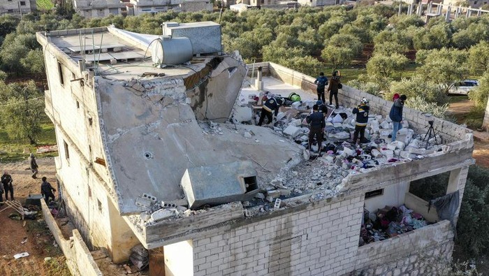 People inspect a destroyed house following an operation by the U.S. military in the Syrian village of Atmeh, in Idlib province, Syria, Thursday, Feb. 3, 2022. U.S. special operations forces conducted a large-scale counterterrorism raid in northwestern Syria overnight Thursday, in what the Pentagon said was a 