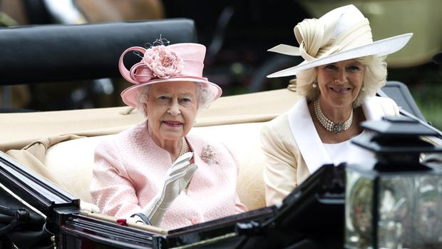 FILE - Britain's Queen Elizabeth II waves to the crowds with Camilla, Duchess of Cornwall  at right, as they arrive by carriage on the first day of the Royal Ascot horse race meeting in Ascot, England, Tuesday, June 18, 2013.  Queen Elizabeth II has offered her support to have the Duchess of Cornwall become Queen Camilla — using a special Platinum Jubilee message to make a significant decision in shaping the future of the monarchy. (AP Photo/Alastair Grant, File)