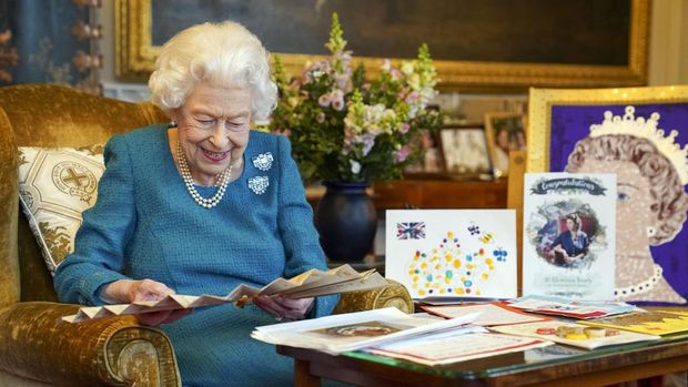 Britain's Queen Elizabeth II looks at a display of memorabilia from her Golden and Platinum Jubilees in the Oak Room at Windsor Castle, Windsor, England, in this undated but recent image that was released on Friday Feb. 4, 2022. Queen Elizabeth II will mark 70 years on the throne Sunday Feb. 6, an unprecedented reign that has made her a symbol of stability as the United Kingdom navigated an age of uncertainty. (Steve Parsons/Pool via AP)