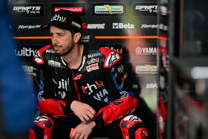 WithU Yamaha RNF MotoGP Teams Italian rider Andrea Dovizioso sits in the pit on the first day of the pre-season MotoGP winter test at the Sepang International Circuit in Sepang on February 5, 2022. (Photo by Ahmad Fadali / AFP)