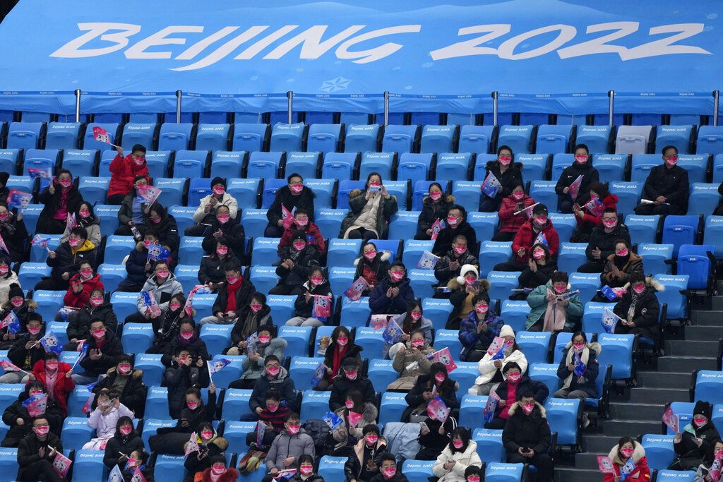 Spectators wait for the start of the men's singles short program at the figure skating competition at the 2022 Winter Olympics, Friday, Feb. 4, 2022, in Beijing. (AP Photo/Natacha Pisarenko)