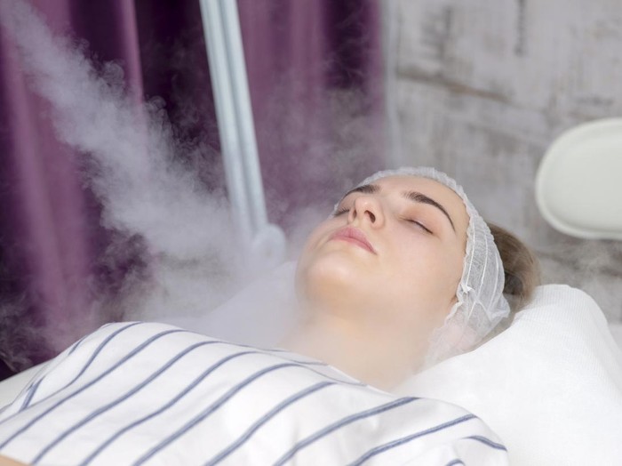 Beauty treatment of young female face, ozone facial steamer