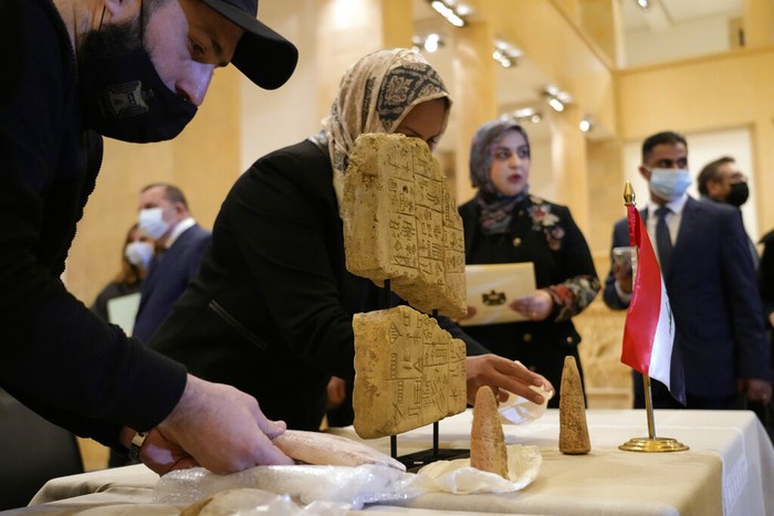 Iraqi antiquities are put on display during a ceremony held at the National Museum of Beirut before 337 artifacts were handed over by Lebanese Minister of Culture Mohammed Murtada to Iraq's ambassador to Lebanon, in Beirut, Lebanon, Sunday, Feb. 6, 2022. Until they were handed over, the artifacts had been kept at the private Nabu Museum in north Lebanon. (AP Photo/Bilal Hussein)