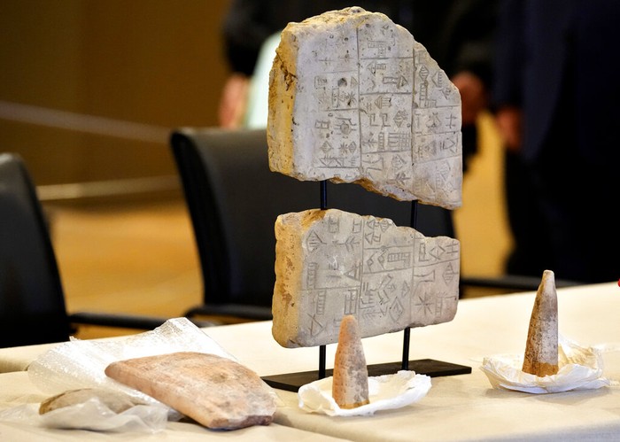 Iraqi antiquities are put on display during a ceremony held at the National Museum of Beirut before 337 artifacts were handed over by Lebanese Minister of Culture Mohammed Murtada to Iraq's ambassador to Lebanon, in Beirut, Lebanon, Sunday, Feb. 6, 2022. Until they were handed over, the artifacts had been kept at the private Nabu Museum in north Lebanon. (AP Photo/Bilal Hussein)
