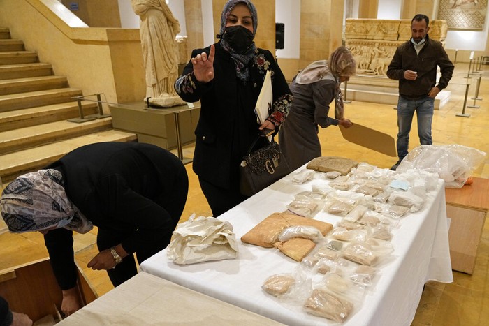 Lebanon Iraq Artifacts Iraqi antiquities are put on display during a ceremony held at the National Museum of Beirut before 337 artifacts were handed over by Lebanese Minister of Culture Mohammed Murtada to Iraq's ambassador to Lebanon, in Beirut, Lebanon, Sunday, Feb. 6, 2022. Until they were handed over, the artifacts had been kept at the private Nabu Museum in north Lebanon. (AP Photo/Bilal Hussein)