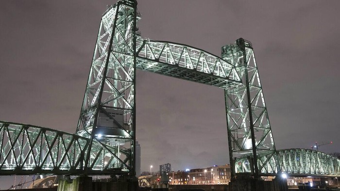 View of the Koningshaven Bridge, known as De Hef, (The Lift), in Rotterdam, Netherlands, Thursday, Feb. 3, 2022. A plan to dismantle the historic bridge in the heart of Dutch port city so that a huge yacht, reportedly being built for Amazon founder Jeff Bezos, can get to the North Sea is unlikely to be plain sailing. Reports this week that the city had already agreed to take apart the recently restored bridge sparked anger in the city, with one Facebook group set up calling for people to pelt the multimillion dollar yacht with rotten eggs. (AP Photo/Peter Dejong)
