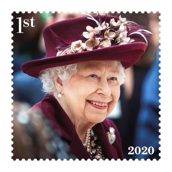 This undated handout provided by Royal Mail on Friday, Feb. 4, 2022 shows of one of eight new stamps showing Queen Elizabeth II smiling, wearing a burgundy outfit and hat, during a visit to the MI5 headquarters in February 2020, which has been issued to mark the monarch's Platinum Jubilee. (Royal Mail via AP)