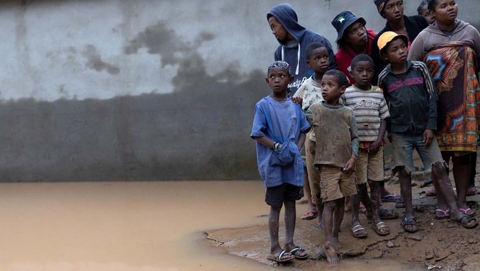 Locals stand next to a flooded area, as Cyclone Batsirai sweeps inland, in Fianarantsoa, Madagascar, February 6, 2022. REUTERS/Alkis Konstantinidis TPX IMAGES OF THE DAY