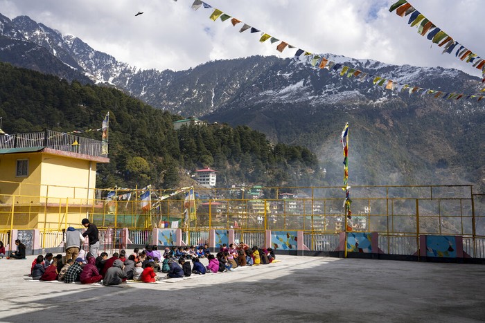 Exile Tibetan children eat lunch against the backdrop of the Dhauladhar range of the Himalaya at the Yongling Creche in Dharmsala, India, Tuesday, Feb. 8, 2022. (AP Photo/Ashwini Bhatia)