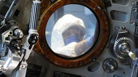 Workers open the glass case enclosing the Apollo 16 lunar capsule at the U.S. Space and Rocket Center in Huntsville, Ala., on Tuesday, Feb. 1, 2022. Following a break in routine maintenance because of the COVID-19 pandemic, the museum is sprucing up the antique spaceship before events marking the 50th anniversary of its flight to the moon in 1972. (AP Photo/Jay Reeves)