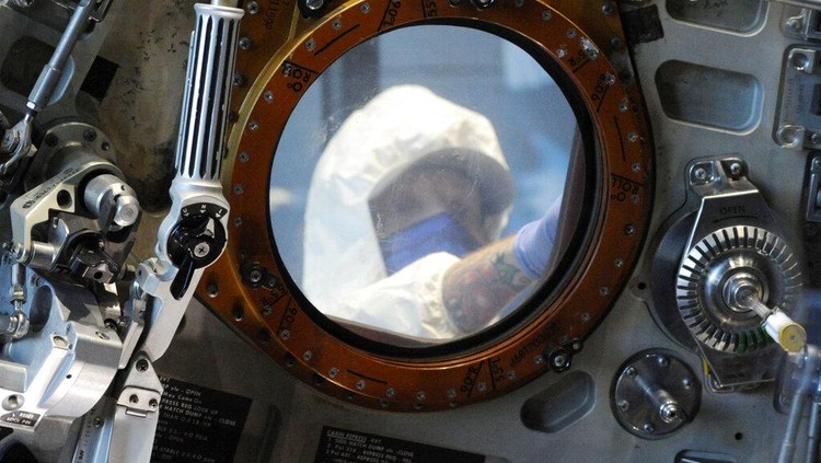 Workers open the glass case enclosing the Apollo 16 lunar capsule at the U.S. Space and Rocket Center in Huntsville, Ala., on Tuesday, Feb. 1, 2022. Following a break in routine maintenance because of the COVID-19 pandemic, the museum is sprucing up the antique spaceship before events marking the 50th anniversary of its flight to the moon in 1972. (AP Photo/Jay Reeves)