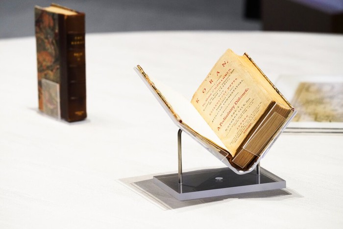 A mover pushes a box holding a Quran owned by U.S. President Thomas Jefferson as it leaves the American pavilion at Dubai Expo 2020 in Dubai, United Arab Emirates, Wednesday, Feb. 9, 2022. The Quran, on its first trip ever outside of the U.S. since being bought by Jefferson, had been on display at the Expo under constant guard. It was packed Wednesday to be returned to the Library of Congress. (AP Photo/Jon Gambrell)