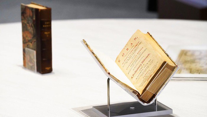 A mover pushes a box holding a Quran owned by U.S. President Thomas Jefferson as it leaves the American pavilion at Dubai Expo 2020 in Dubai, United Arab Emirates, Wednesday, Feb. 9, 2022. The Quran, on its first trip ever outside of the U.S. since being bought by Jefferson, had been on display at the Expo under constant guard. It was packed Wednesday to be returned to the Library of Congress. (AP Photo/Jon Gambrell)