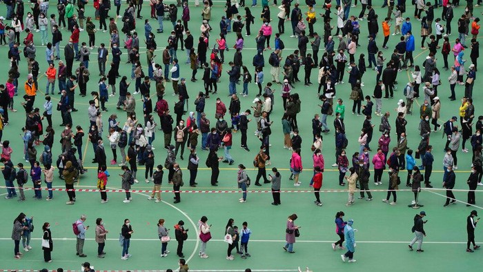 Residents get tested for the coronavirus at a temporary testing center for COVID-19 in Hong Kong, Wednesday, Feb. 9, 2022. (AP Photo/Kin Cheung)