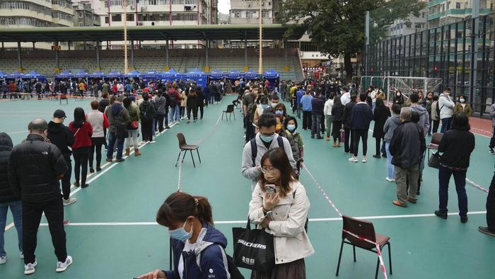 Residents get tested for the coronavirus at a temporary testing center for COVID-19 in Hong Kong, Wednesday, Feb. 9, 2022. (AP Photo/Kin Cheung)