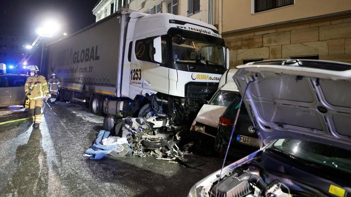 Firefighters work at the site of an accident on late February 8, 2022 in Fuerth, southern Germany, after a truck ploughed into a row of cars, setting some of them on fire. - A lorry driver under the influence of alcohol rammed into over 30 cars and caused a house fire in Germanys Bavaria region on the evening of February 8, 2022, injuring himself and two others. The 50-year-old driver 