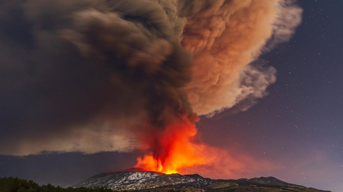 Lava flows from the Mt. Etna volcano, as seen from Nicolosi, Sicily, southern Italy, Thursday, Feb. 10, 2022. (AP Photo/Salvatore Allegra)