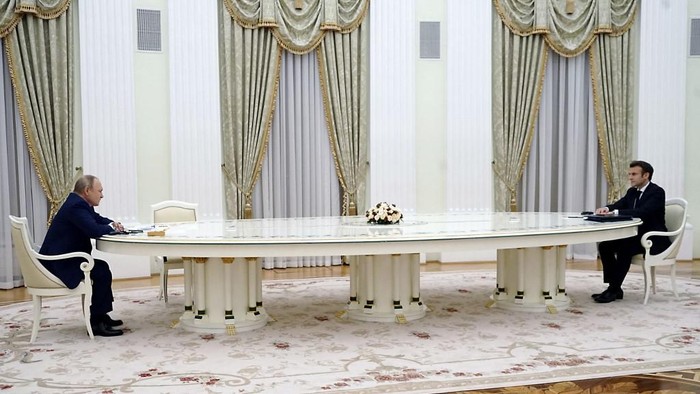 French President Emmanuel Macron (R) meets with Russian President Vladimir Putin (L) in Moscow on February 7, 2022, for talks in an effort to find common ground on Ukraine and NATO, at the start of a week of intense diplomacy over fears Russia is preparing an invasion of its pro-Western neighbour. (Photo by SPUTNIK / AFP)