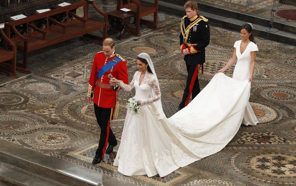 FILE - In this Friday, April 29, 2011 file photo, Britain's Prince William, foreground left, and his wife Kate, the Duchess of Cambridge, foreground right, during their wedding service at Westminster Abbey in London. With less than a month to go till she marries Prince Harry at Windsor Castle on May 19, Meghan Markle would most likely have chosen her wedding dress - though what it looks like is expected to remain a top secret until the last minute. Princess Diana’s 1981 wedding gown, with its puff sleeves, romantic ruffles and dramatic train, defined the ‘80s fairytale bridal look. More recently, when Kate Middleton married Prince William in 2011, the long-sleeved lace gown she chose sparked a trend for more covered-up, traditional lace bridal dresses that lasted years. (AP Photo/Kirsty Wigglesworth, file)