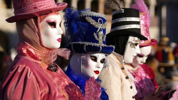 Boats sail during the water parade, part of the Venice Carnival, in Venice, Italy, Sunday, Feb. 13, 2022. Two years after the pandemic shut down celebrations, the Venice carnival in the historical lagoon city is back, attracting people from around the world. (AP Photo/Antonio Calanni)
