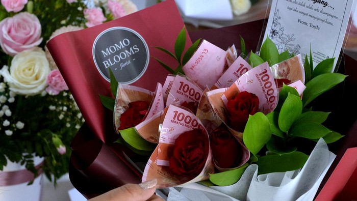 Perajin menyusun buket bunga pesanan pembeli untuk kado perayaan hari Valentine di Momo Blooms Florist, Denpasar, Bali, Minggu (13/2/2022). Buket dengan rangkaian berbagai jenis bunga serta buket uang tersebut dijual dengan harga Rp200 ribu hingga Rp2 juta dan ramai dipesan oleh ratusan pembeli menjelang perayaan hari Valentine. ANTARA FOTO/Fikri Yusuf/foc.