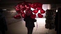 Seorang pedagang menjual balon berbentuk hati di momen Hari Valentine di kawasan Kyiv, Ukraina, Senin (14/2/2022) waktu setempat.