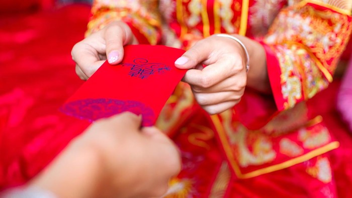 Chinese bride giving red pocket lucky money in the wedding