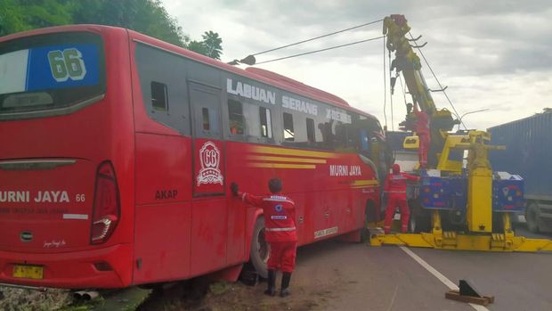 Sebuah mobil bus berpenumpang masuk parit di Tol Jakarta-Tangerang. Kecelakaan itu terjadi karena sopir bus menghindari mobil yang mengerem mendadak. (dok Istimewa)