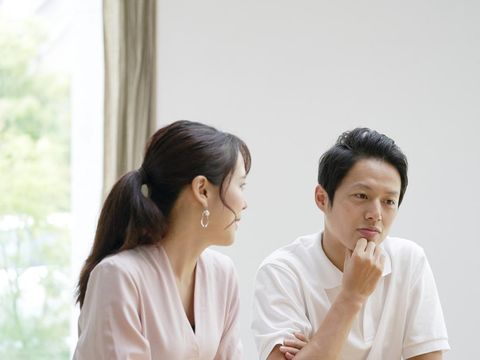 Asian couple talking at home