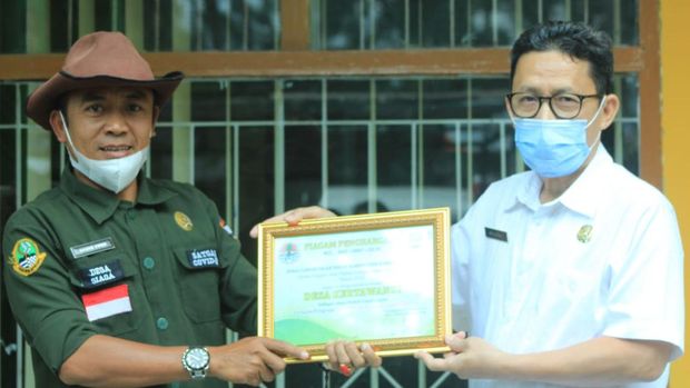 Warga tengah mengangkut sampah di lingkungannya.
