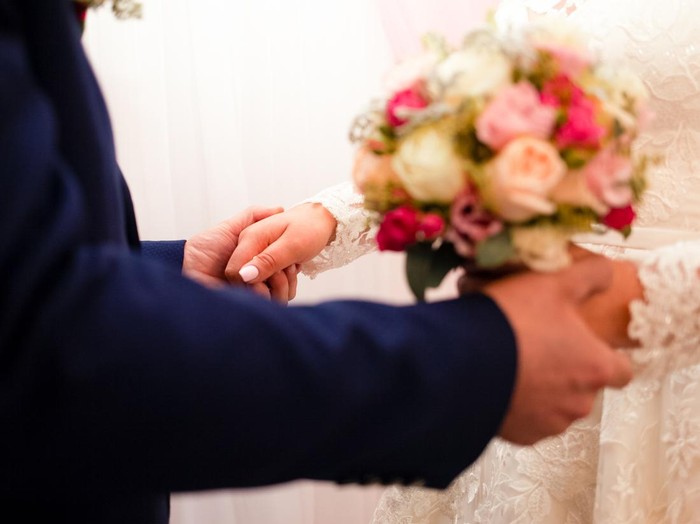 The bride and groom exchange rings, close-up.
