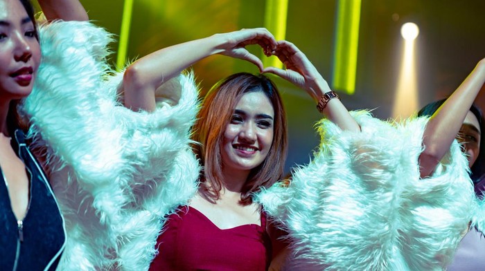 Group of women friend having fun at party in dancing club at night . Social gathering event and nightlife entertainment concept .