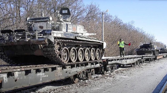 In this photo taken from video provided by the Russian Defense Ministry Press Service on Tuesday, Feb. 15, 2022, a Russian tank is loaded onto railway platforms after the end of military drills in South Russia. In what could be another sign that the Kremlin would like to lower the temperature, Russias Defense Ministry announced Tuesday that some units participating in military exercises would begin returning to their bases. (Russian Defense Ministry Press Service via AP)