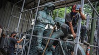 Pekerja memasang rangka untuk mengemas patung Presiden Joko Widodo yang menaiki sepeda motor di NuArt Sculpture Park, Bandung, Jawa Barat, Jumat (18/2/2022).