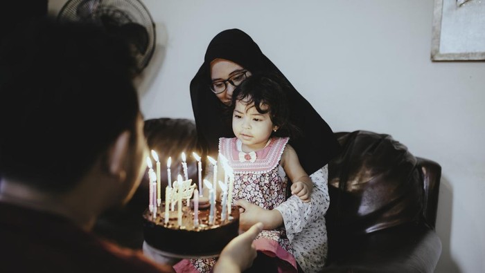 husband Presenting wife with Birthday Cake