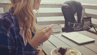Natasha sepertinya penggemar berat kudapan manis. Ia menikmati seporsi cake cokelat dengan krim di pinggir pantai.  Foto: Instagram @natashabassett