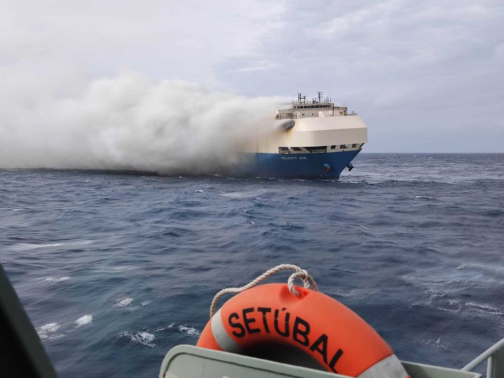 CORRECTS CREDIT TO PORTUGUESE NAVY INSTEAD OF AIR FORCE In this undated photo provided by the Portuguese Navy, smoke billows from the burning Felicity Ace car transport ship as seen from the Portuguese Navy NPR Setubal ship southeast of the mid-Atlantic Portuguese Azores Islands. The ship's crew were taken by helicopter to Faial island on the archipelago, about 170 kilometers (100 miles) away on Wednesday, Feb. 16, 2022. There were no reported injuries. (Portuguese Navy via AP)