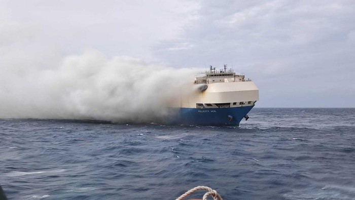 CORRECTS CREDIT TO PORTUGUESE NAVY INSTEAD OF AIR FORCE In this undated photo provided by the Portuguese Navy, smoke billows from the burning Felicity Ace car transport ship as seen from the Portuguese Navy NPR Setubal ship southeast of the mid-Atlantic Portuguese Azores Islands. The ships crew were taken by helicopter to Faial island on the archipelago, about 170 kilometers (100 miles) away on Wednesday, Feb. 16, 2022. There were no reported injuries. (Portuguese Navy via AP)