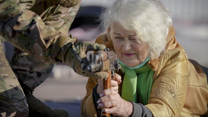 Valentyna Konstantynovska, 79 years-old, holds a weapon during basic combat training for civilians, organized by the Special Forces Unit Azov, of Ukraines National Guard, in Mariupol, Donetsk region, eastern Ukraine, Sunday, Feb. 13, 2022. The United States is evacuating almost all of the staff from its embassy in Kyiv as Western intelligence officials warn that a Russian invasion of Ukraine is increasingly imminent. (AP Photo/Vadim Ghirda)