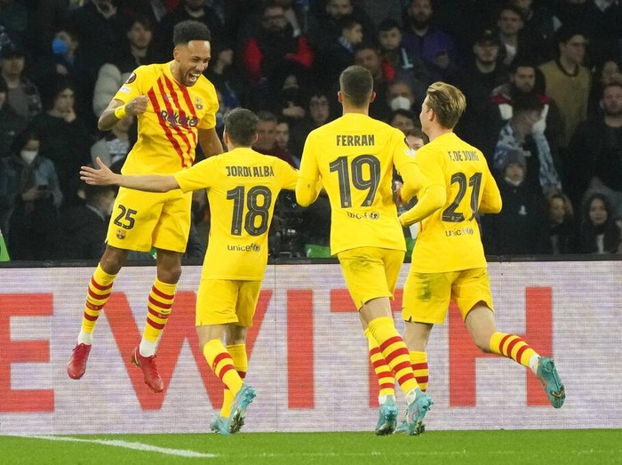 Barcelona's Pierre-Emerick Aubameyang, left, celebrates with teammates after scoring during the Europa League Soccer match between Napoli and Barcelona at the San Paolo stadium in Naples, Italy, Thursday, Feb. 24, 2022. (AP Photo/Gregorio Borgia)