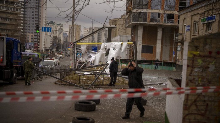 Police officers inspect area after an apparent Russian strike in Kyiv Ukraine, Thursday, Feb. 24, 2022. Russian President Vladimir Putin on Thursday announced a military operation in Ukraine and warned other countries that any attempt to interfere with the Russian action would lead to 