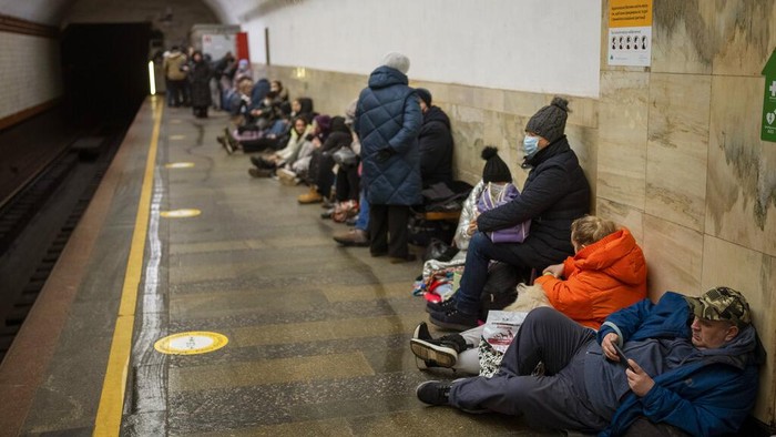 People rest in the Kyiv subway, using it as a bomb shelter in Kyiv, Ukraine, Thursday, Feb. 24, 2022. Russia has launched a full-scale invasion of Ukraine, unleashing airstrikes on cities and military bases and sending troops and tanks from multiple directions in a move that could rewrite the world's geopolitical landscape. (AP Photo/Emilio Morenatti)