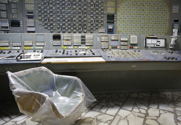 FILE - An operators arm-chair covered with plastic sits in an empty control room of the 3rd reactor at the Chernobyl nuclear plant, in Chernobyl, Ukraine, on April 20, 2018. Among the most worrying developments on an already shocking day, as Russia invaded Ukraine on Thursday, was warfare at the Chernobyl nuclear plant, where radioactivity is still leaking from historys worst nuclear disaster 36 years ago.(AP Photo/Efrem Lukatsky, File)