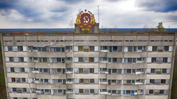 FILE - The rusty emblem of the Soviet Union is seen on the roof of an apartment building in the ghost town of Pripyat close to the Chernobyl nuclear plant, Ukraine, on April 15, 2021. Among the most worrying developments on an already shocking day, as Russia invaded Ukraine on Thursday, was warfare at the Chernobyl nuclear plant, where radioactivity is still leaking from history's worst nuclear disaster 36 years ago.(AP Photo/Efrem Lukatsky, File)
