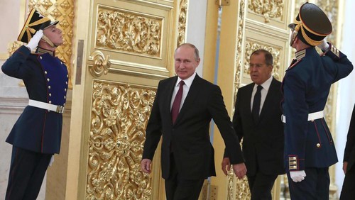 FILE - Russian President Vladimir Putin and Foreign Minister Sergei Lavrov walk past honour guards as they attend a ceremony to receive diplomatic credentials from newly appointed foreign ambassadors at the Kremlin in Moscow, Russia, Thursday, Oct. 11, 2018. In the wake of the 2022 invasion of Ukraine, U.S. sanctions are targeting Putin and a handful of individuals believed to be among his closest security advisers, including Lavrov. (Sergei Karpukhin/Pool Photo via AP, File)