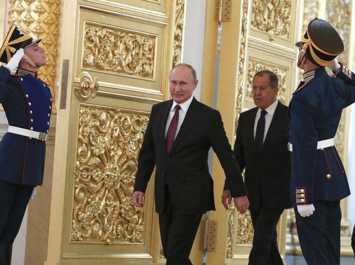 FILE - Russian President Vladimir Putin and Foreign Minister Sergei Lavrov walk past honour guards as they attend a ceremony to receive diplomatic credentials from newly appointed foreign ambassadors at the Kremlin in Moscow, Russia, Thursday, Oct. 11, 2018. In the wake of the 2022 invasion of Ukraine, U.S. sanctions are targeting Putin and a handful of individuals believed to be among his closest security advisers, including Lavrov. (Sergei Karpukhin/Pool Photo via AP, File)